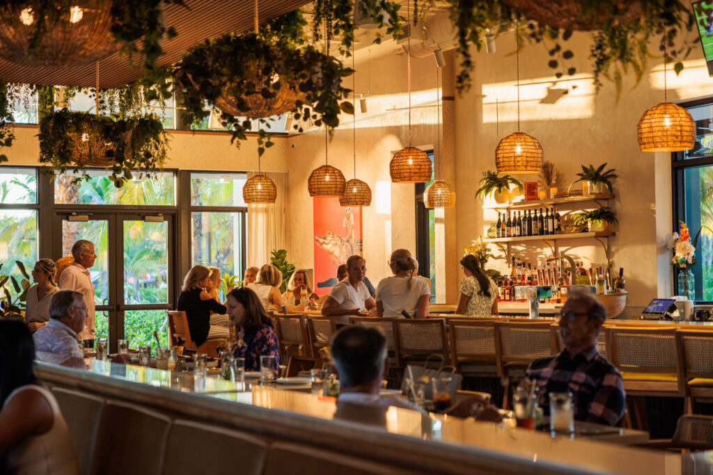Busy bar and happy hour crowd at Florida Room Fort Lauderdale with indoor-outdoor seating and lively atmosphere