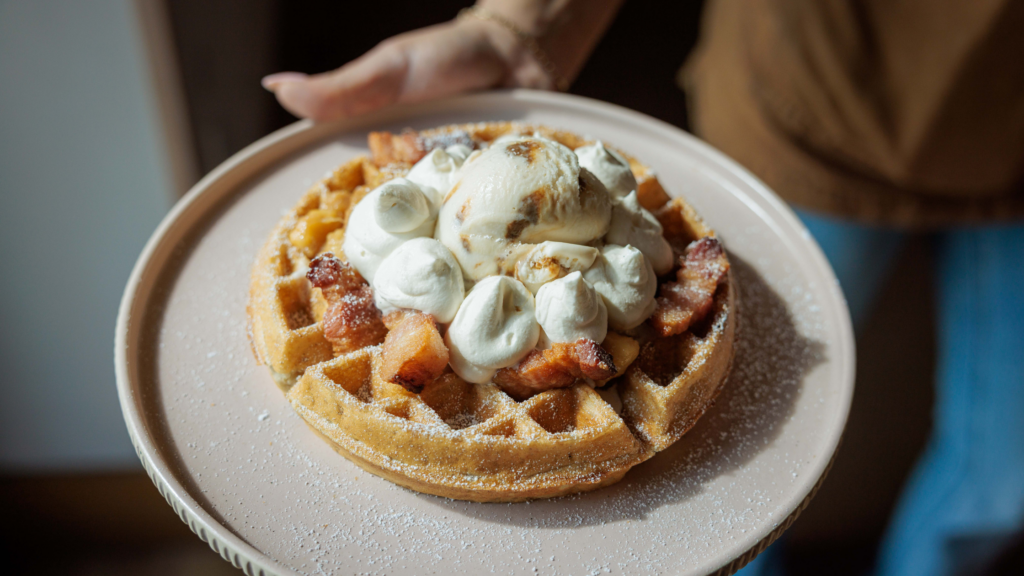 Waffle topped with whipped cream and ice cream at a Fort Lauderdale brunch restaurant 