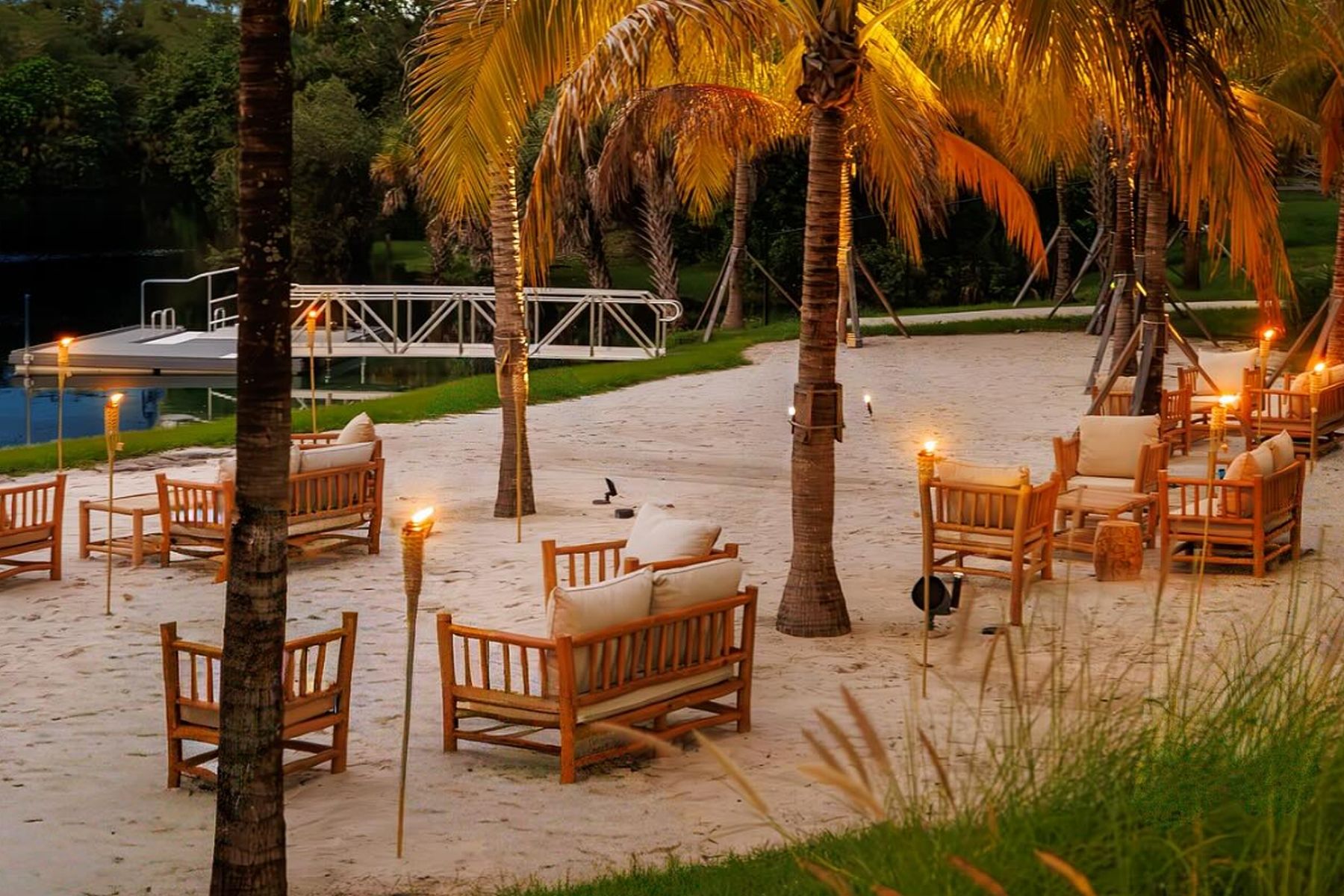 Florida Room Beach Lakeside Seating at Sunset Lakeside beach club seating with palm trees and lounge chairs at the Florida Room Fort Lauderdale