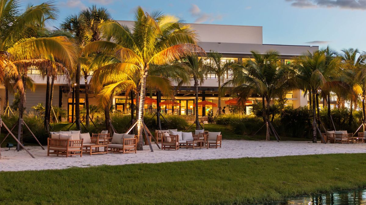 Outdoor lakeside seating with palm trees at Florida Room in Fort Lauderdale