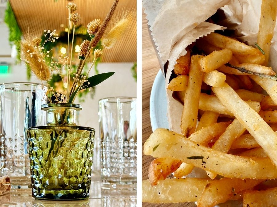 Table setting with decorative green glass vase and a side of seasoned fries at Florida Room